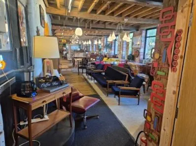 The main aisle of the Scandex floor at Cullingworth Mills — coffee bar, lamps and mid-century seating
