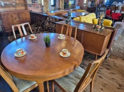 Teak round dining table and chairs, dressed for tea, on the Scandex floor at Cullingworth Mills