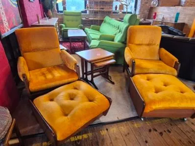 Pair of mustard velour armchairs with footstools at Scandex, Cullingworth