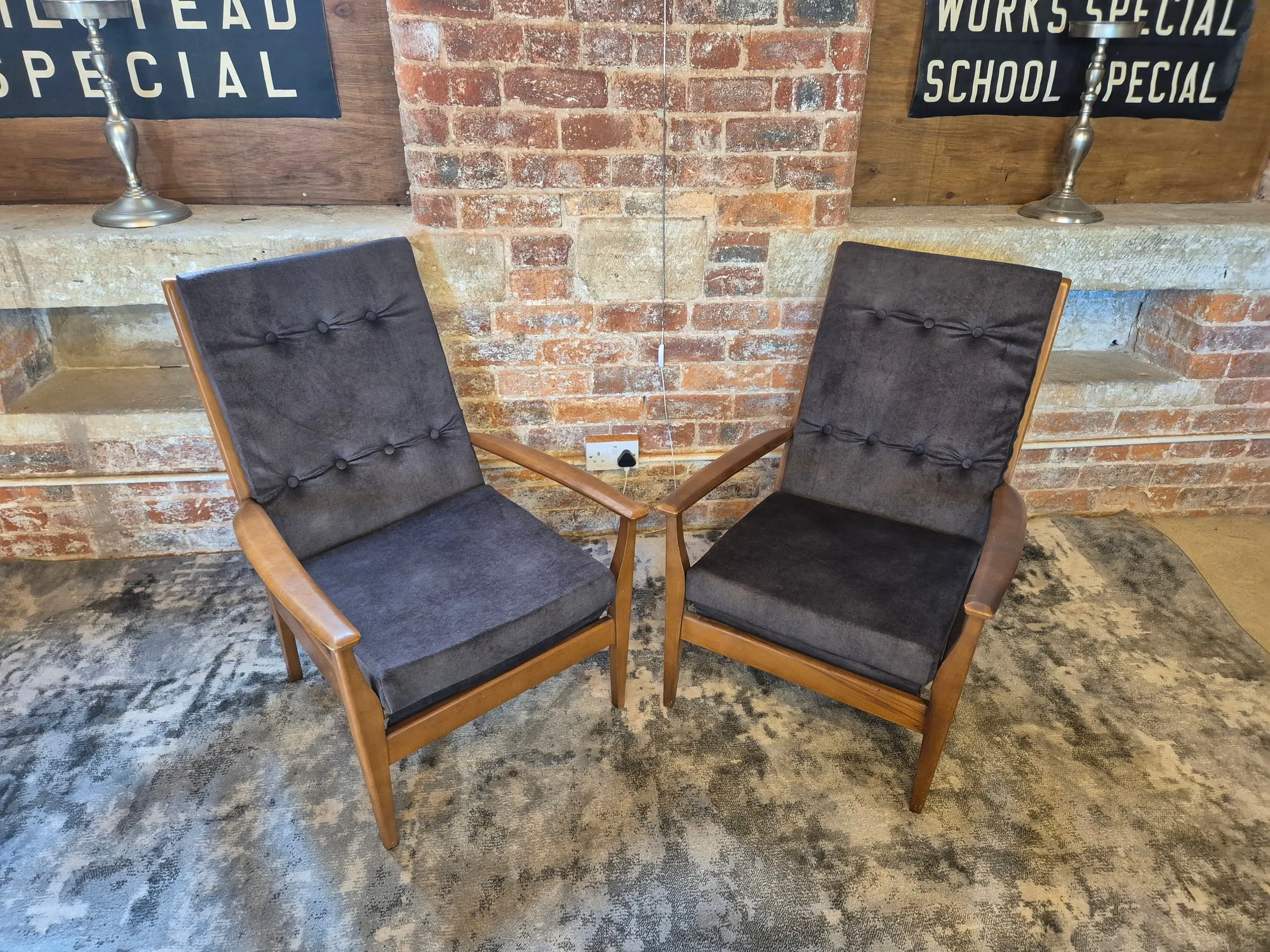 Pair of mid-century teak reclining lounge chairs with buttoned upholstery at Scandex, Cullingworth.